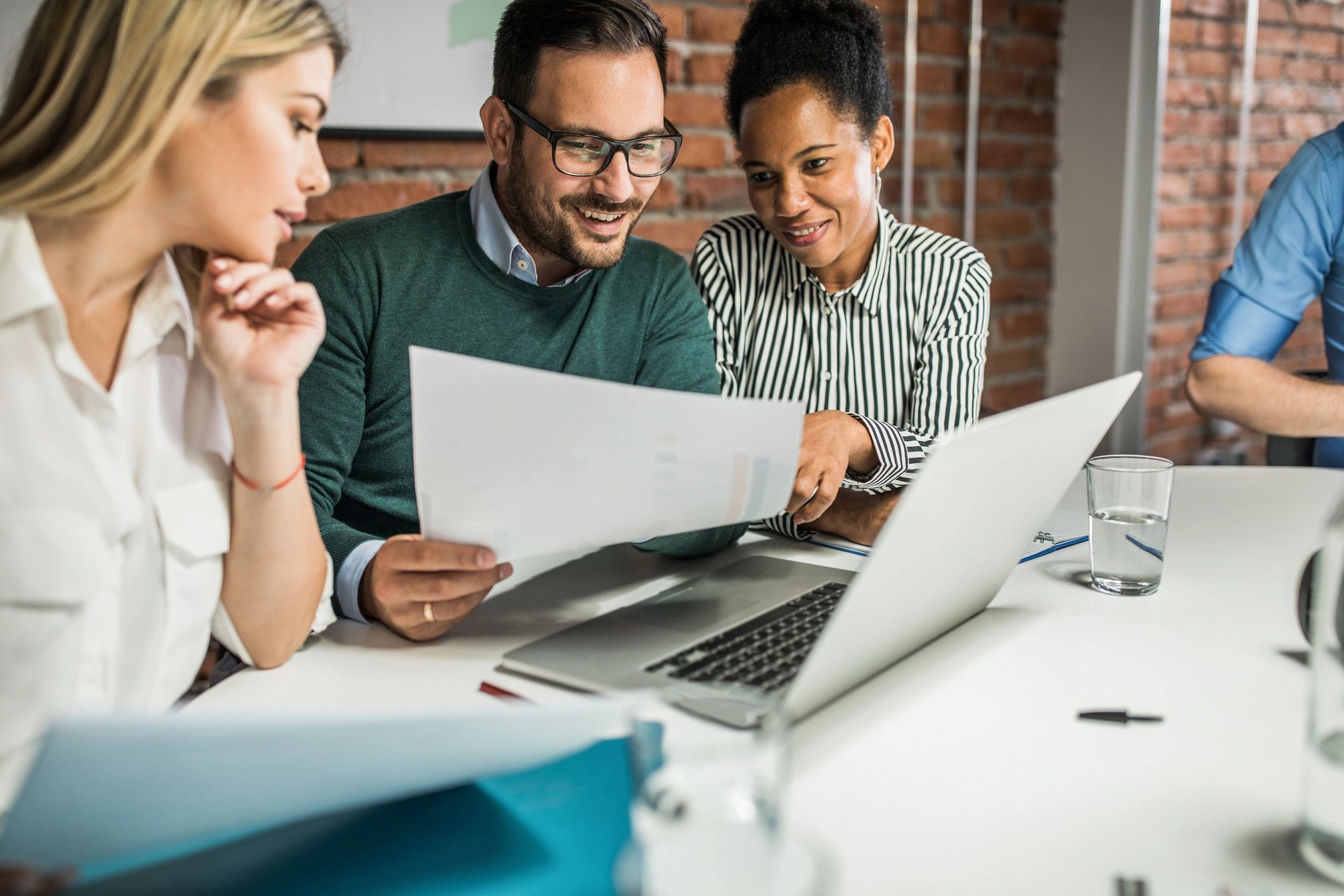 Finance team reviewing documents together in an office